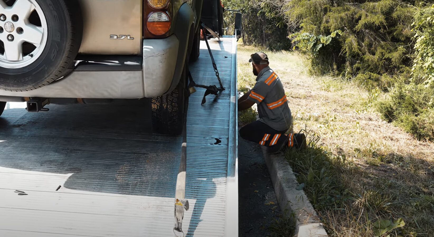 Professional flatbed towing service securing vehicle in Palmview, TX